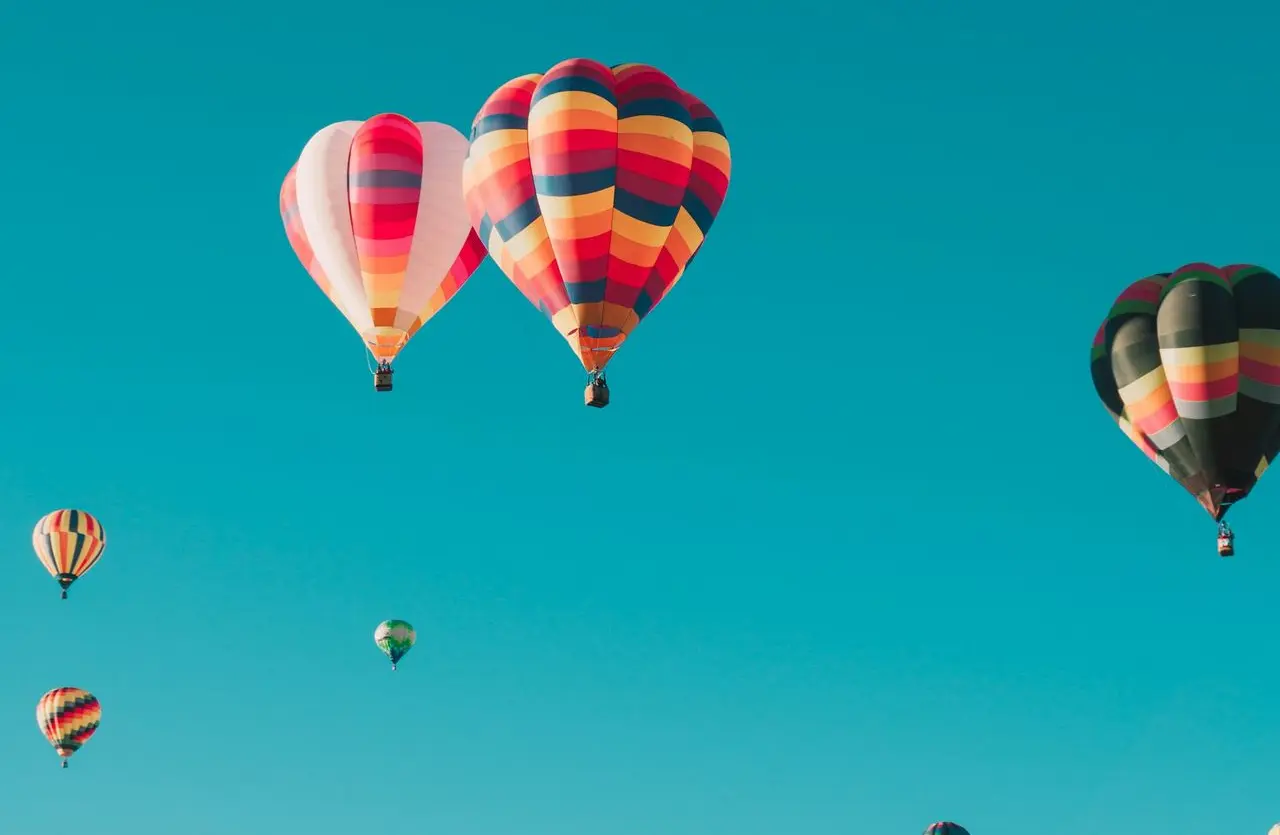 assorted hot air balloons flying at high altitude during daytime